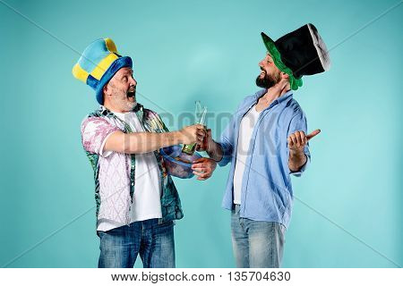The two football fans over blue background