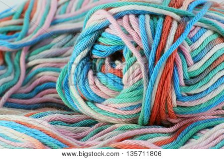 bales of wool in different colors with white background