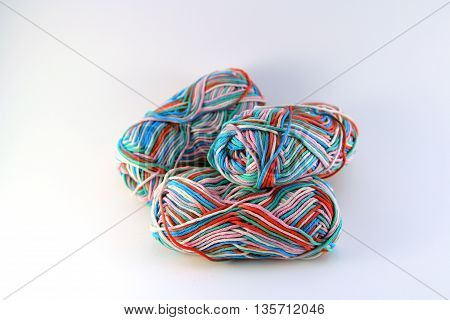bales of wool in different colors with white background