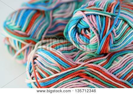 bales of wool in different colors with white background