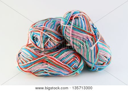 bales of wool in different colors with white background