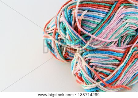 bales of wool in different colors with white background