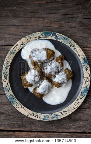 A plate with Romanian sarmale - stuffed vine leaves