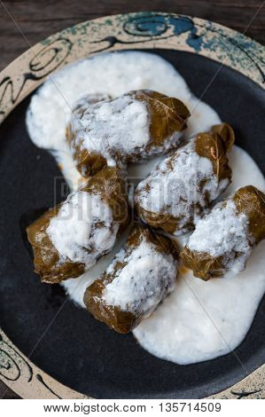 A plate with Romanian sarmale - stuffed vine leaves