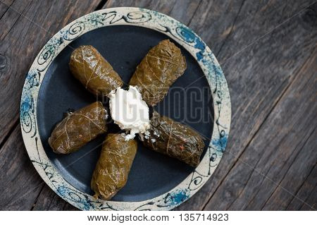 A plate with Romanian sarmale - stuffed vine leaves