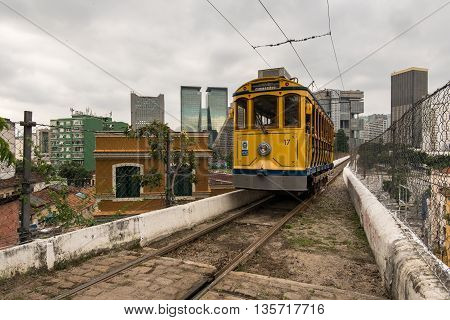 Rio de Janeiro, Brazil - June 18, 2016: The new version of iconic bonde tram is passing on the top of the Arch of Lapa, which was once an aqueduct.