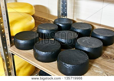 Cheese Factory Warehouse With Shelves Of Capretto And Latteria