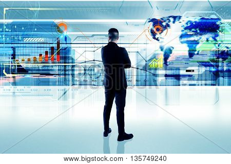 Business man in office looks futuristic interface