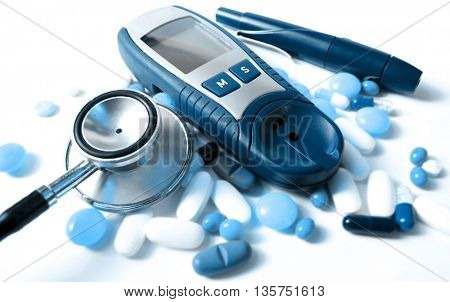 stethoscope,pills and device for measuring blood sugar level