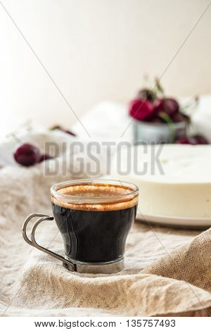 Morning coffee with light summer dessert. Vanilla bavarian mousse cake with cream cheese and whipped cream. White plate. Close up.