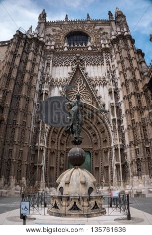 statue in front of the Seville Cathedral Enterence