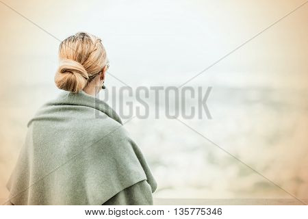 Back View Of A Woman With Tied Blond Hair..
