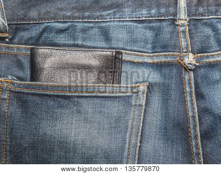 Jeans texture Blue denim jeans with black lether wallet (focus on wallet)