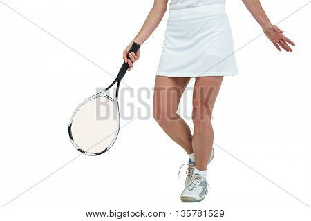 Athlete playing tennis with a racket on white background