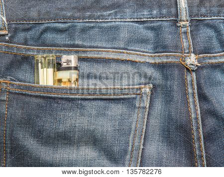 Jeans texture Blue denim jeans with cigarette lighter (focus on cigarette lighter)
