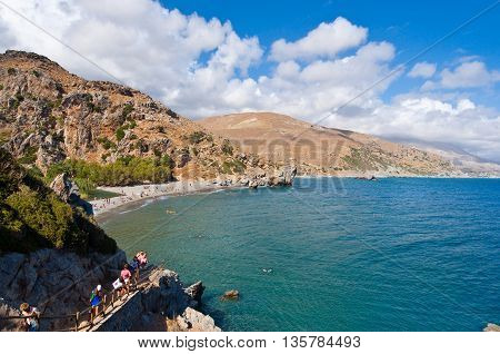 CRETEGREECE-JULY 23:Tourists go down to the Preveli Beach on July 232014 on Crete Greece. The beach of Preveli is situated 40 km south of the main town and is the most idyllic beach in Crete.