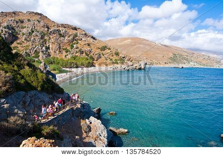 CRETEGREECE-JULY 23:Tourists come down on the Preveli Beach on July 232014 on Crete Greece. The beach of Preveli is situated 40 km south of the main town and is the most idyllic beach in Crete.