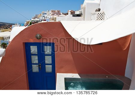 Oia cave houses on the lip of the volcanic crater on the island of Thera (Santorini) Greece.