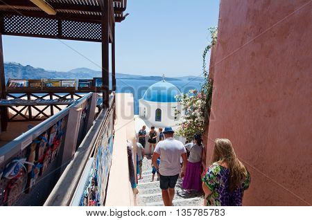 SANTORINIOIA-JULY 28: Tourists go look at Oia sights on July 242018 in Oia town on the Santorini island Greece.