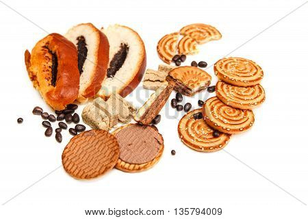 There are Pieces of  Roll with poppyseed,Cookies,Halavah,Chocolate Peas,Tasty Sweet Food on the White Background