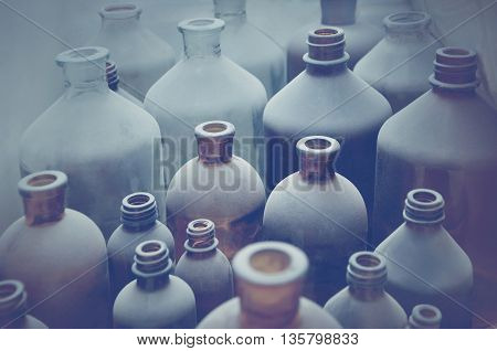 old pharmacy bottles covered with dust in pharmaceutical laboratory