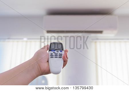 Air conditioner split type embed on wall of living room.