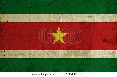 Suriname flag painting on old paper background