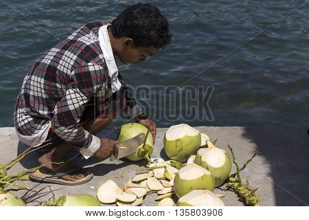Unidentified Men Selling Coconuts