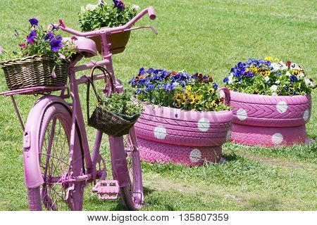 Decprated old bicycle on grass. Colorful image