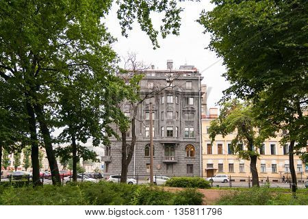 Dark gray eclectic house on Avenue of Rimsky-Korsakov in St. Petersburg. View from the garden Nikolsky.