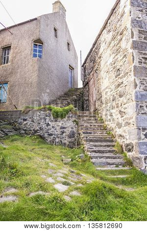 Traditional buildings and stone stairways of a Scottish fishing village