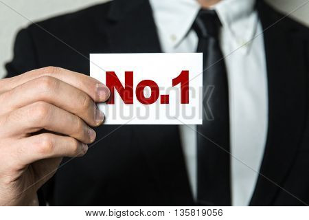 Business man holding a card with the text: No.1 