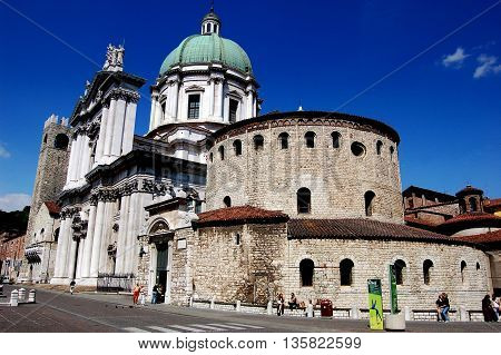 Brescia, Italy - May 30, 2006: The Rotondo (Winter Cathedral /Duomo) of Santa Maria Maggiore dating to the 11th century (on right) and the 16-1th century Duomo Nuovo (new cathedral) at left