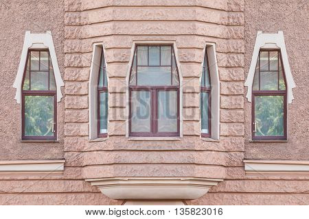 Several windows in a row and bay window on facade of urban apartment building front view St. Petersburg Russia