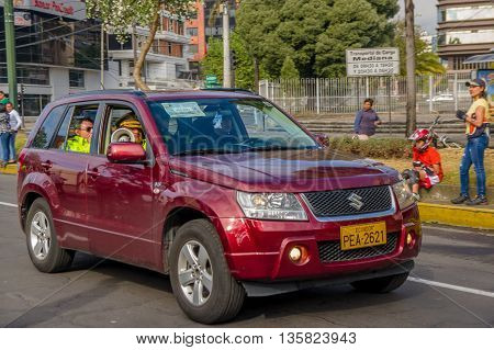 QUITO, ECUADOR - JULY 7, 2015: Police inside a wine color car, Suzuki big vitara. People outside,