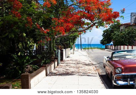 Red american cabriolet vintage car parked in Varadero Cuba