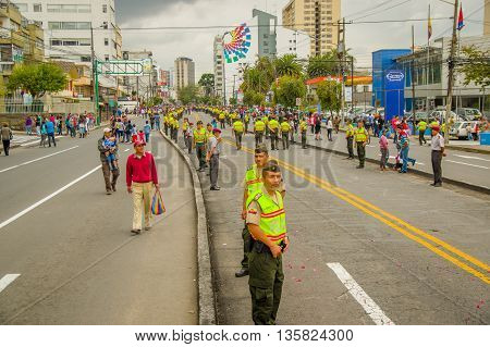 QUITO, ECUADOR - JULY 7, 2015: Lots of people expecting to see pope Francisco in Quito, police on the street.