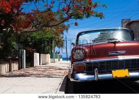 Red american cabriolet classic car parked in Varadero Cuba