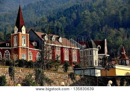 Bai Lu China - November 17 2013: Steepled tower and large meeting hall with gothic windows in the Sino-French village built following the 2008 earthquake