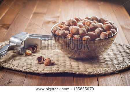 Hazelnuts in a bowl ready to use. Tool for chopping nuts woven cloth. Healthy food.