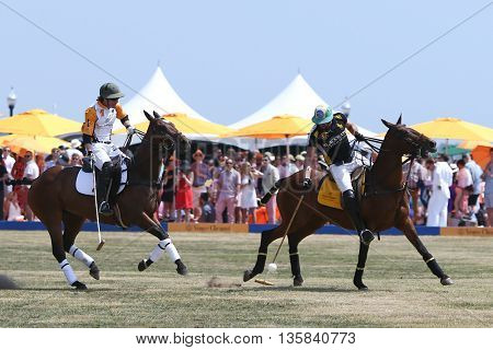 JERSEY CITY, NJ-MAY 30: Rico Mansur (R) handles the ball as Edward Hartman gives chase during a polo match at the Veuve Clicquot Polo Classic at Liberty State Park on May 30, 2015 in Jersey City, NJ.