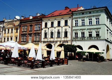 Tarnow Poland - June 12,  2010: Outdoor cafés and restaurants front the handsome Renaissance and Baroque buildings lining the Rynek Market Square