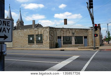 JOLIET, ILLINOIS / UNITED STATES - JUNE 3, 2015: An abandoned building in downtown Joliet, with the spires of the historic Saint Joseph Roman Catholic Church visible in the background..