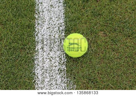 NEW YORK - JULY 21, 2015: Slazenger Wimbledon Tennis Ball on grass tennis court. Slazenger Wimbledon Tennis Ball exclusively used and endorsed by The Championships, Wimbledon