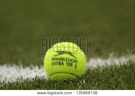NEW YORK - JULY 21, 2015: Slazenger Wimbledon Tennis Ball on grass tennis court. Slazenger Wimbledon Tennis Ball exclusively used and endorsed by The Championships, Wimbledon