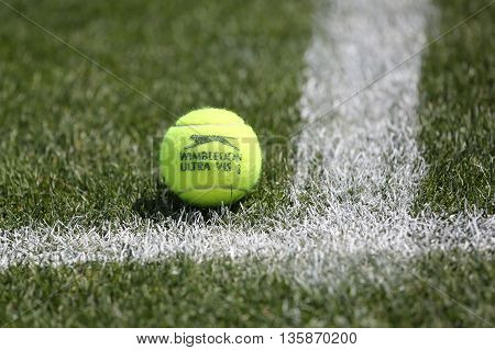 NEW YORK - JULY 21, 2015: Slazenger Wimbledon Tennis Ball on grass tennis court. Slazenger Wimbledon Tennis Ball exclusively used and endorsed by The Championships, Wimbledon