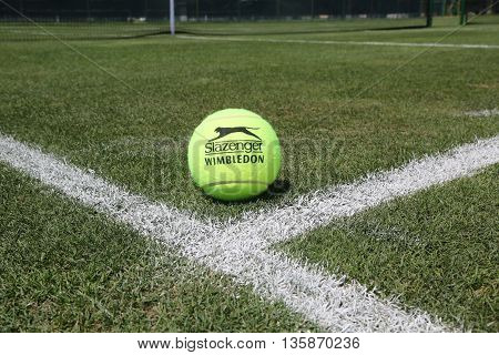 NEW YORK - JULY 21, 2015: Slazenger Wimbledon Tennis Ball on grass tennis court. Slazenger Wimbledon Tennis Ball exclusively used and endorsed by The Championships, Wimbledon