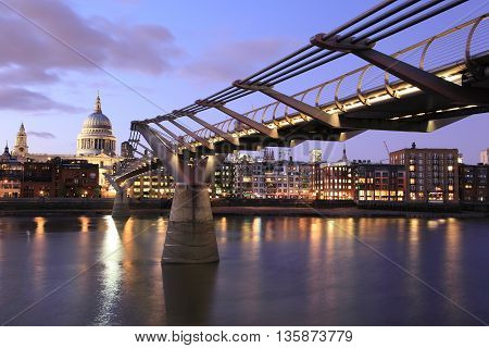 LONDON - SEPTEMBER 6: Night cityscape at the Millennium Bridge on September 6, 2009 in London, England. Millennium Bridge above River Thames is one of the most visited landmarks in London.