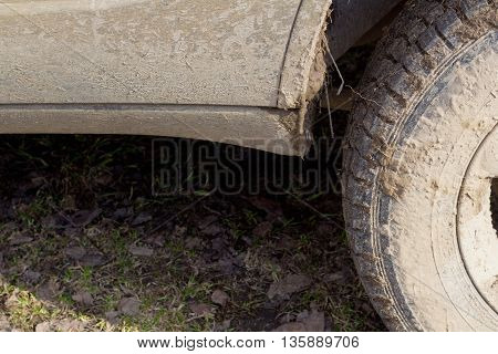 a fragment of a sports utility vehicle. dirty thresholds wheel.