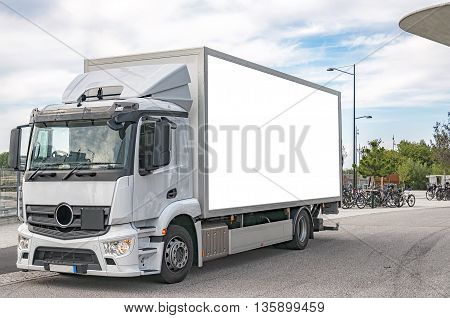 A blank bilboard on the side of a white truck customizable for your advertising needs.
